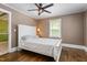 Inviting bedroom featuring a white bed frame, wood floors, and ample natural light at 701 Veterans Dr, Elon, NC 27244