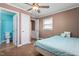 Bedroom featuring an attached bathroom with wood floor and a ceiling fan at 701 Veterans Dr, Elon, NC 27244