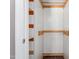 Walk-in closet with open shelving and wooden rods for efficient storage and organization at 701 Veterans Dr, Elon, NC 27244