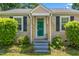 Close-up of a home's front door with stone accents and decorative shutters at 701 Veterans Dr, Elon, NC 27244
