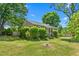 Single-story home with a well-maintained lawn and mature trees at 701 Veterans Dr, Elon, NC 27244