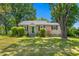 Charming single-story home featuring a well-manicured lawn and mature trees at 701 Veterans Dr, Elon, NC 27244