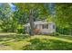 Beautiful home with a lush green lawn and mature trees providing ample shade at 701 Veterans Dr, Elon, NC 27244