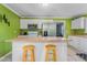 Bright kitchen featuring white cabinets, modern appliances, and a breakfast bar with seating at 701 Veterans Dr, Elon, NC 27244