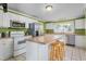 Spacious kitchen with white cabinets, an island, and stainless steel appliances at 701 Veterans Dr, Elon, NC 27244