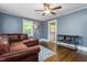 Cozy living room with hardwood floors, a ceiling fan, and natural light at 701 Veterans Dr, Elon, NC 27244