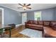 Comfortable living room with hardwood floors, a ceiling fan, and natural light at 701 Veterans Dr, Elon, NC 27244