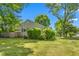 Side view of a home with a well-maintained lawn and mature trees at 701 Veterans Dr, Elon, NC 27244