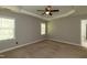 Bright bedroom with tray ceiling, carpet flooring and natural light at 716 Lakeview Ave, Wake Forest, NC 27587