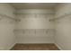 Spacious walk-in closet with built-in shelving, and carpet flooring at 716 Lakeview Ave, Wake Forest, NC 27587