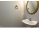Stylish half bathroom with pedestal sink, gold trim mirror, and neutral wall color at 716 Lakeview Ave, Wake Forest, NC 27587