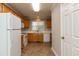 Open kitchen with oak cabinetry and white appliances and ample counter space at 716 Lakeview Ave, Wake Forest, NC 27587
