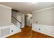 Spacious room with hardwood floors, decorative trim, and staircase at 716 Lakeview Ave, Wake Forest, NC 27587