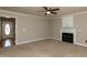 Welcoming living room features a fireplace, carpet flooring, and a front entry view at 716 Lakeview Ave, Wake Forest, NC 27587