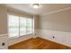 Inviting living room with hardwood floors, large window, and classic trim work at 716 Lakeview Ave, Wake Forest, NC 27587