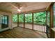 An enclosed porch offers a private outdoor living space with a ceiling fan and wooded view at 716 Lakeview Ave, Wake Forest, NC 27587