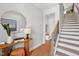 Inviting entryway with wooden floors, an octagonal mirror, stairs, and stylish decor at 805 Hyperion Aly, Wake Forest, NC 27587