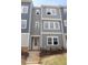 Charming three-story townhome featuring a classic design, inviting entrance, and well-maintained landscaping at 805 Hyperion Aly, Wake Forest, NC 27587