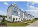 New townhome exterior showcasing modern design, well-maintained landscaping, and a community street view at 805 Hyperion Aly, Wake Forest, NC 27587