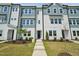 Charming new build with blue and white siding, landscaping and walkway to the black front door at 805 Hyperion Aly, Wake Forest, NC 27587