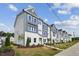 New build townhomes feature stylish exteriors and landscaping, creating a welcoming neighborhood street view at 805 Hyperion Aly, Wake Forest, NC 27587
