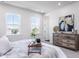 Bright bedroom with a large window offering scenic views, complemented by a stylish dresser and decor at 806 Hillfarm Dr, Wake Forest, NC 27587