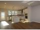 Bright kitchen featuring stainless steel appliances, large island, and white cabinets at 806 Hillfarm Dr, Wake Forest, NC 27587