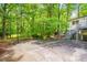 Backyard featuring a basketball hoop, shed, patio, stairs, and lush green trees at 823 Churchill Dr, Chapel Hill, NC 27517
