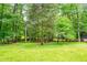 Lush backyard view through trees, providing a private and green outdoor space at 823 Churchill Dr, Chapel Hill, NC 27517