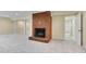Large basement featuring a brick fireplace, neutral walls, and access to other areas at 823 Churchill Dr, Chapel Hill, NC 27517