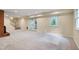 Spacious basement with a brick fireplace, stairs, and walkout patio doors at 823 Churchill Dr, Chapel Hill, NC 27517