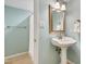 Charming bathroom featuring a pedestal sink and a framed mirror over tan tile flooring at 823 Churchill Dr, Chapel Hill, NC 27517