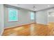 Spacious bedroom boasting hardwood floors, two windows, and a walk-in shower en suite at 823 Churchill Dr, Chapel Hill, NC 27517