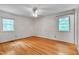 Bright, airy bedroom with hardwood floors and natural light from two windows at 823 Churchill Dr, Chapel Hill, NC 27517