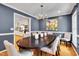 Stylish dining area features a modern chandelier and open access to an adjacent kitchen at 823 Churchill Dr, Chapel Hill, NC 27517