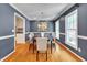 Elegant dining room with hardwood floors, modern chandelier, and a sophisticated color palette at 823 Churchill Dr, Chapel Hill, NC 27517