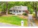 Charming Cape Cod style home boasts a welcoming blue front door and beautifully landscaped front yard at 823 Churchill Dr, Chapel Hill, NC 27517