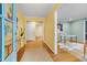 Inviting foyer with hardwood floors, bright yellow walls, and access to a study area at 823 Churchill Dr, Chapel Hill, NC 27517