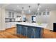 Beautiful kitchen with a large island, bar seating, and pendant lighting at 823 Churchill Dr, Chapel Hill, NC 27517