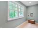 Bright laundry room with large window offering natural light and a view of the surrounding trees at 823 Churchill Dr, Chapel Hill, NC 27517