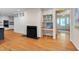 Bright living room with fireplace, built-in desk and cabinets, and hardwood flooring at 823 Churchill Dr, Chapel Hill, NC 27517