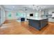 Bright, open-concept kitchen and living room area with hardwood floors at 823 Churchill Dr, Chapel Hill, NC 27517