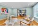 Serene living room with hardwood floors, study area, and an abundance of natural light at 823 Churchill Dr, Chapel Hill, NC 27517