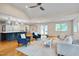 Living room featuring hardwood floors, comfortable seating, open to a modern kitchen at 823 Churchill Dr, Chapel Hill, NC 27517