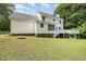 The back of the house has a lawn and a deck at 84 Sycamore Lake Rd, Siler City, NC 27344
