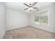 Neutral bedroom with a ceiling fan, carpet floors, and bright windows at 84 Sycamore Lake Rd, Siler City, NC 27344