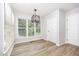 Bright breakfast nook with natural light from large windows and light-colored vinyl floors at 84 Sycamore Lake Rd, Siler City, NC 27344