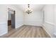 Empty dining room with wood floors, a chandelier, and natural light at 84 Sycamore Lake Rd, Siler City, NC 27344