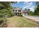 Two-story house with a front porch and a driveway leading to a two-car garage at 84 Sycamore Lake Rd, Siler City, NC 27344