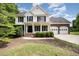 Charming two-story home featuring a covered porch and a two-car garage at 84 Sycamore Lake Rd, Siler City, NC 27344